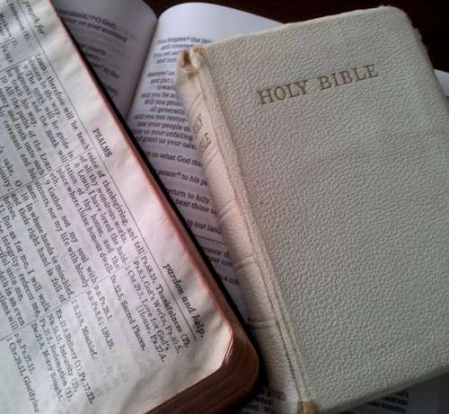 Three Bibles, two open and one closed to illustrate dangers of overreliance on Bible reading plans