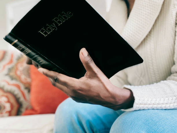 Close-up of a woman reading the Bible on a sofa to illustrate the point of mistaking plan progress for spiritual health