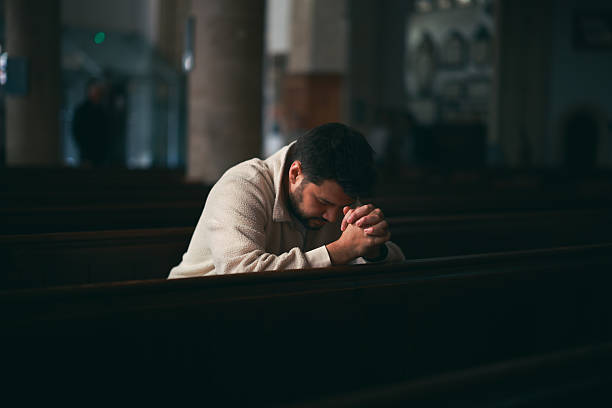 A man sitting in a church in quiet contemplation