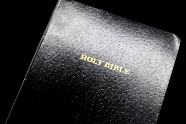 A black Bible against a black background