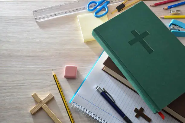 A green Bible with an assortment of stationery 