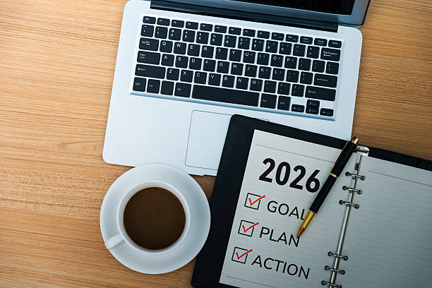 2026 new year resolutions on notepad with coffee and laptop for reasons consistent Bible reading should be part of your annual planning
