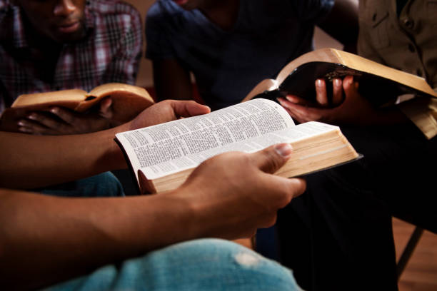 Young adults meeting together in a Bible study illustrating how the Gospels give a blueprint for Christian living