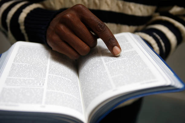 African man reading the bible in a church to show determination of how long you are planning to engage