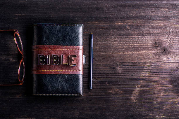 A Bible on a wooden platform with a pen and spectacles on the side to depict why is Bible verse mapping important